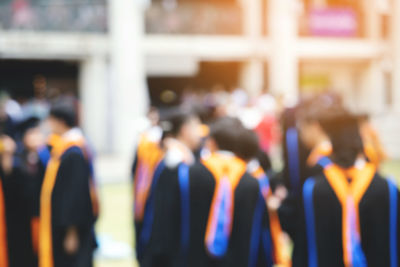 Defocused image of people standing against blurred background