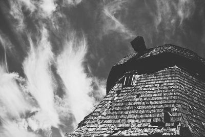 Low angle view of built structure against cloudy sky