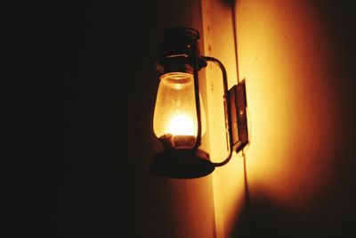 Close-up of illuminated light bulb in darkroom