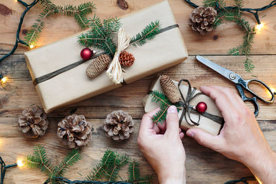 Midsection of woman wrapping christmas present