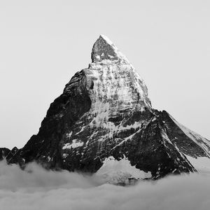 Low angle view of snowcapped mountain against clear sky