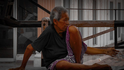 Midsection of woman sitting on seat
