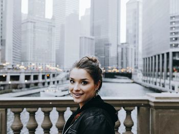 Portrait of smiling young woman in city