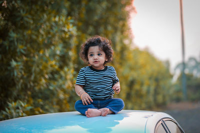 Portrait of cute girl playing in car