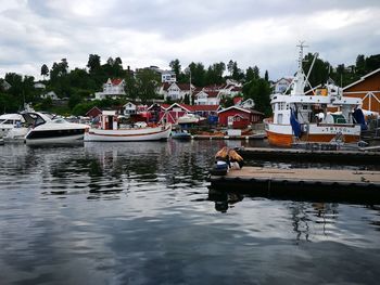 Boats sailing in river against sky