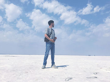 Full length of man standing on land against sky