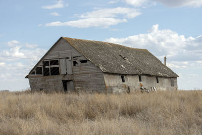 Old building on field against sky