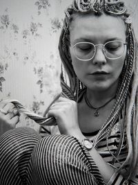 High angle view of young woman sitting on bed