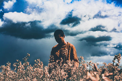 Low angle view of man standing against sky