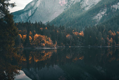 Scenic view of lake by mountains during autumn