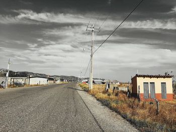 Road amidst buildings against sky