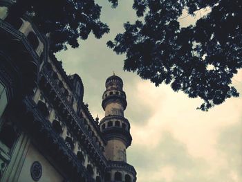 Low angle view of building against cloudy sky