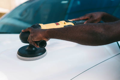 Cropped hand of man repairing car