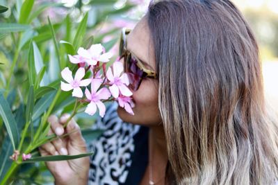 Close-up portrait of woman with pink flower