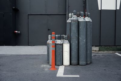 Gas cylinders on street against building