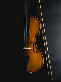 Cropped image of violin against black background