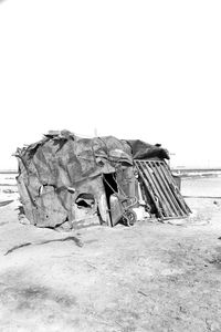 Damaged building on field against clear sky