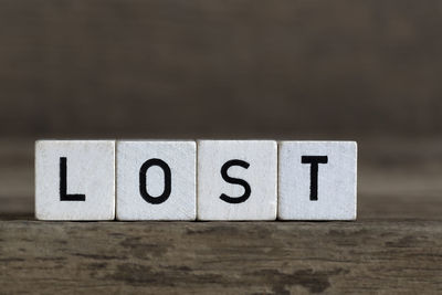 Lost, written in cubes on a wooden background