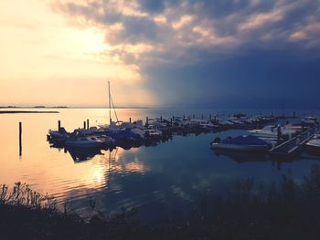 Boats in marina at sunset