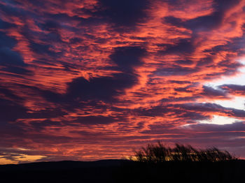 Low angle view of dramatic sky during sunset