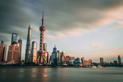 View of buildings in city against cloudy sky