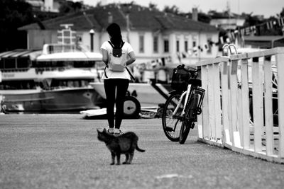 Rear view of woman walking on footpath