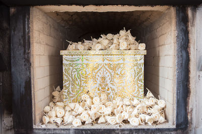 Close-up of bread in container on wall