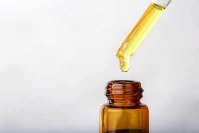 Close-up of glass bottle against white background