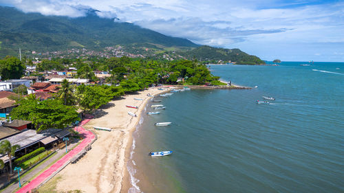 High angle view of sea and mountains against sky