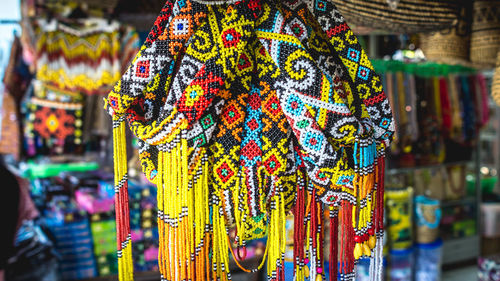 Close-up of decorations hanging in market stall for sale