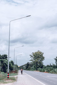 Street by road against sky