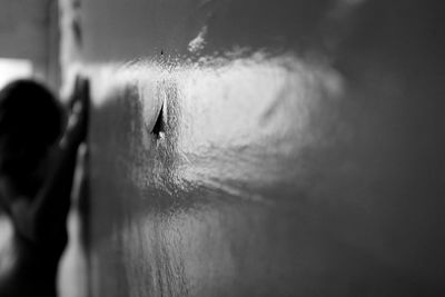 Close-up of man looking away against wall