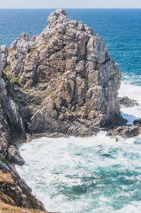 Scenic view of rocks on sea shore