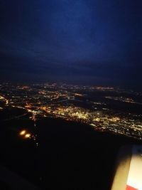 Aerial view of illuminated city against sky at night