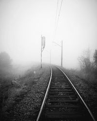 Railroad track during foggy weather