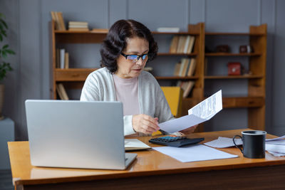 Businesswoman using laptop on table