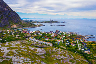 High angle view of townscape by sea against sky