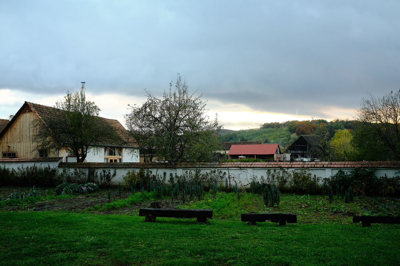 HOUSE ON FIELD AGAINST SKY