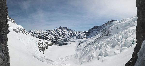 Scenic view of snowcapped mountains against sky