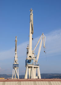 Low angle view of crane against sky