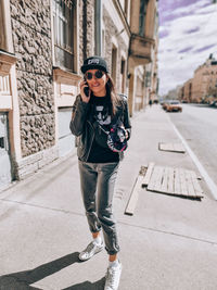 Full length of young woman walking on street