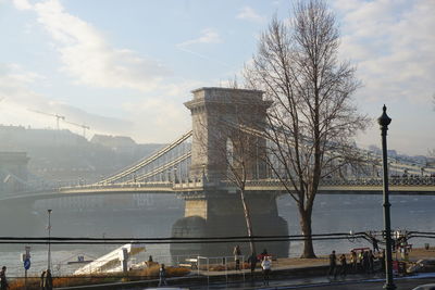 Bridge over river with city in background