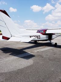 Airplane on runway against sky