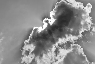 Low angle view of smoke emitting from clouds against sky