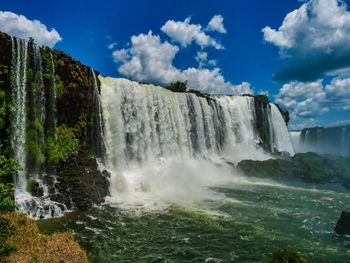 Scenic view of waterfall against sky