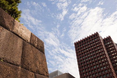 Low angle view of building against cloudy sky