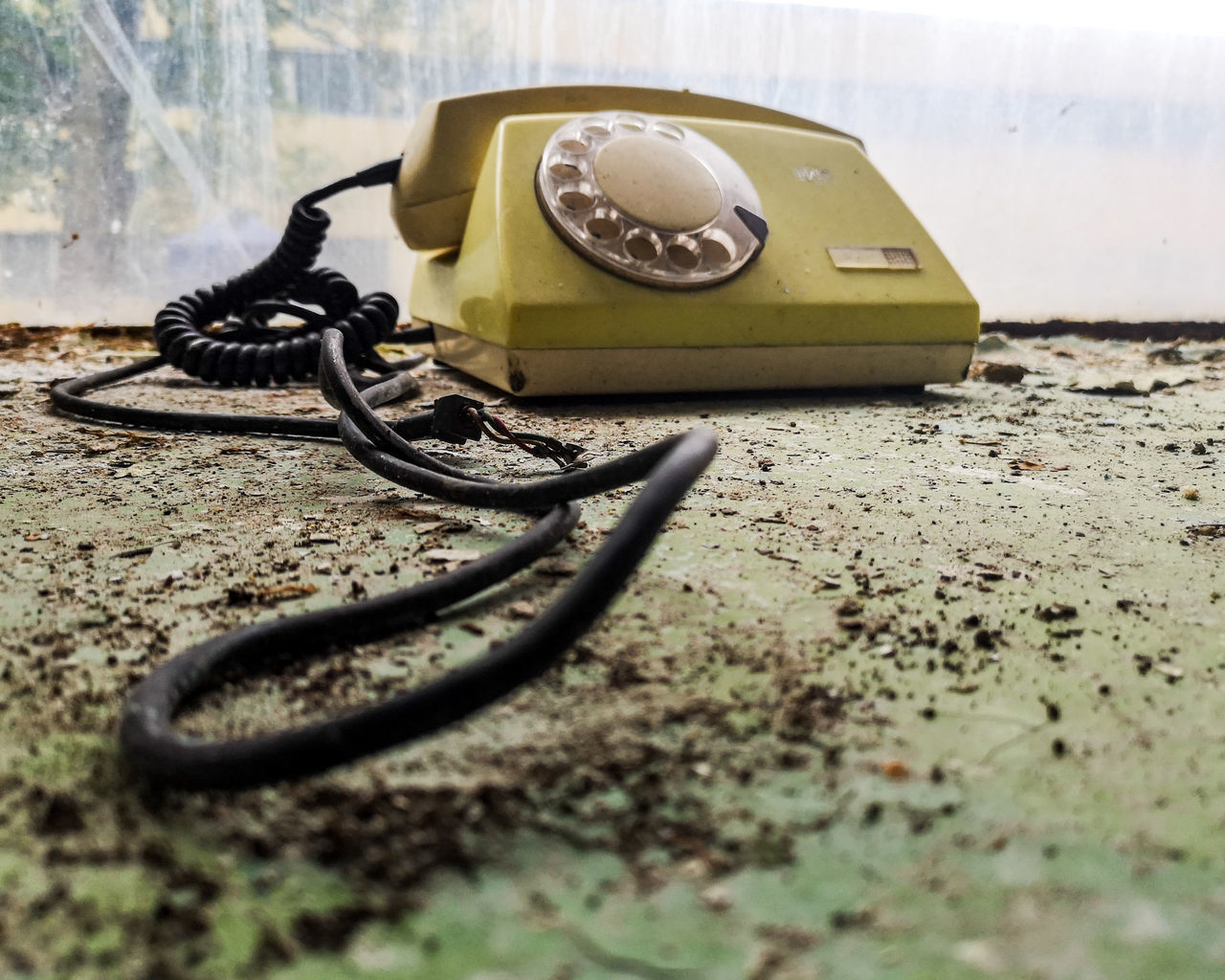 CLOSE-UP OF OLD TELEPHONE ON TABLE