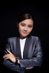 Portrait of a beautiful young woman over black background