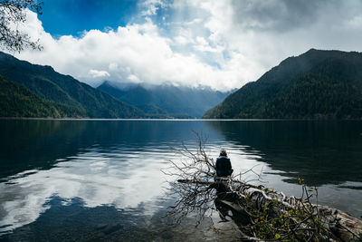 Man looking at lake against mountain range
