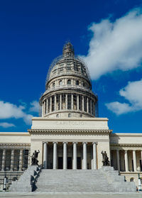 Low angle view of historic building against blue sky